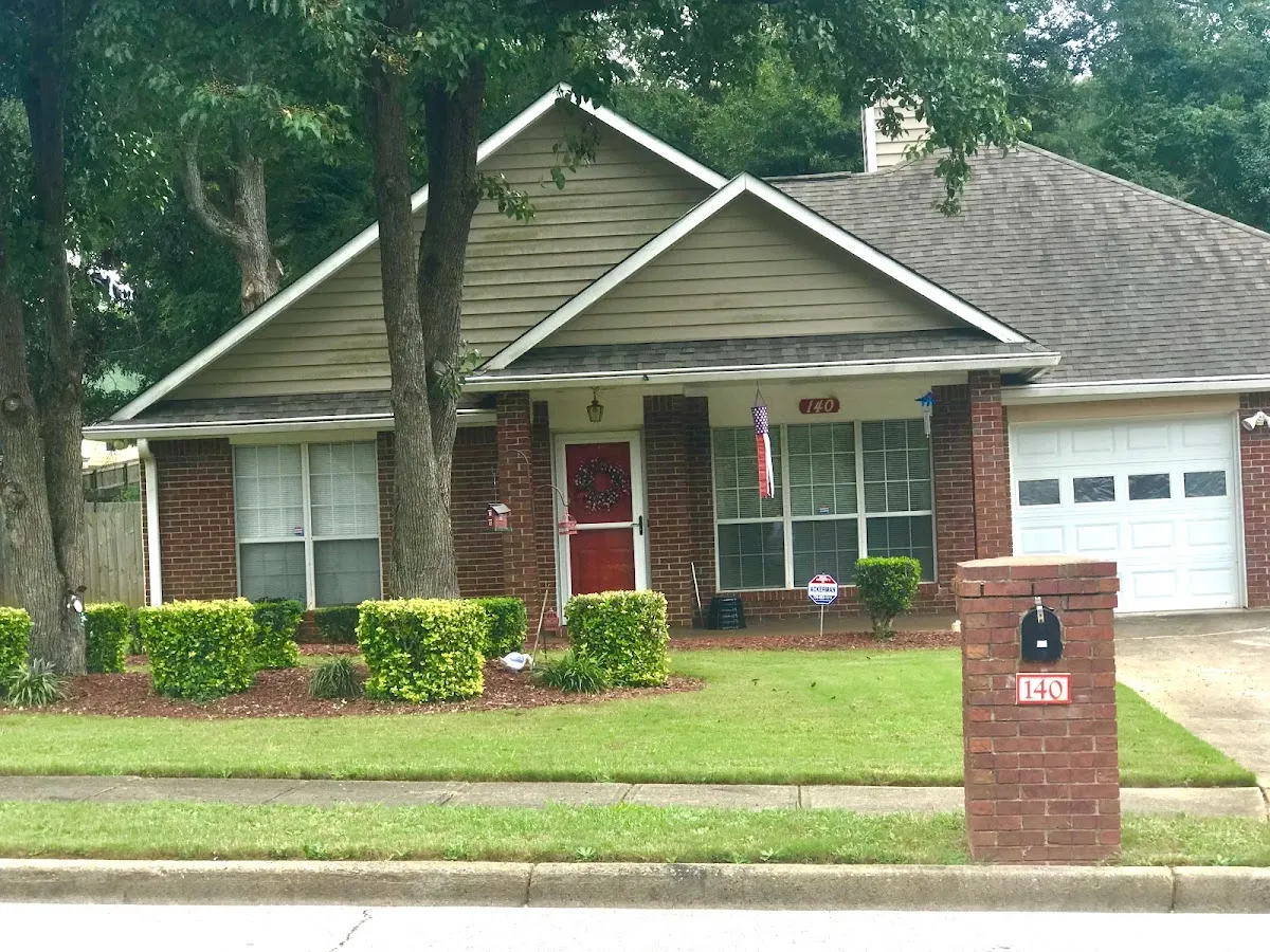 Neatly trimmed hedges along a healthy green front lawn